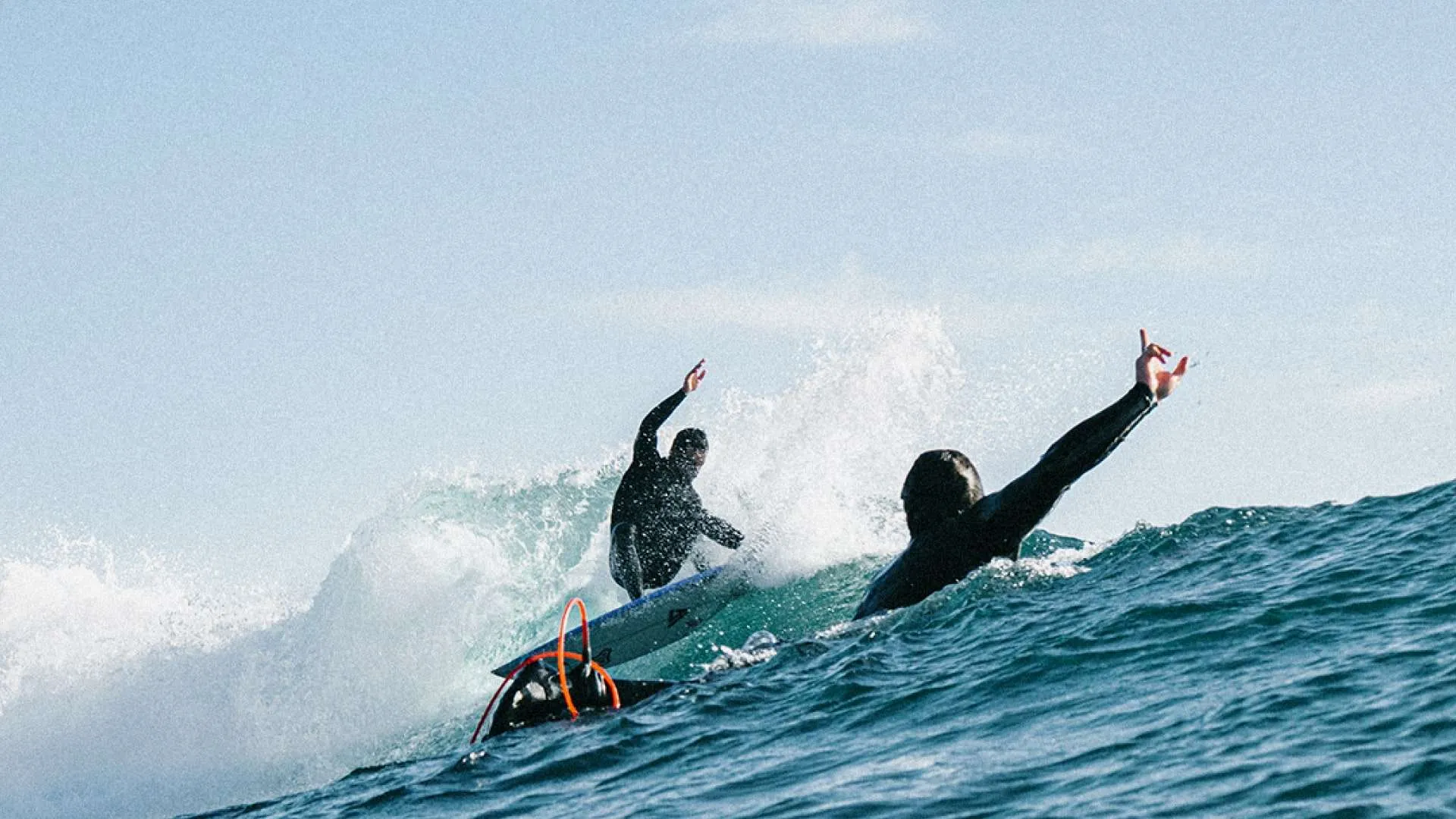 surfers having fun while surfing with their onboard surfboards
