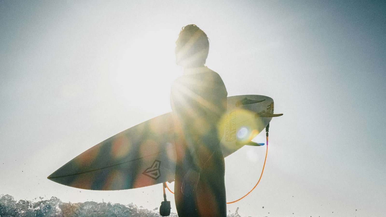 Surfer holding his Surfboard after surfing